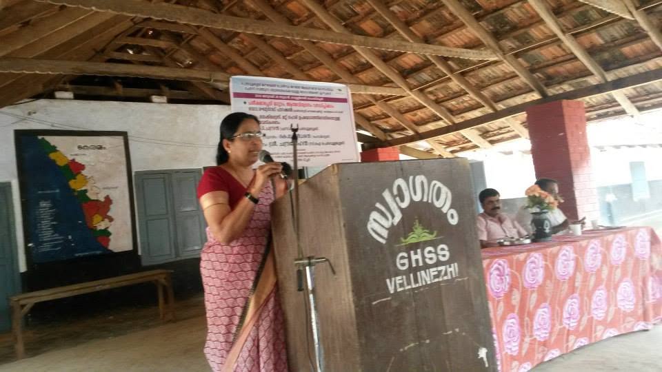 A speaker at the lectern during a health programme at GHSS Vellinezhi